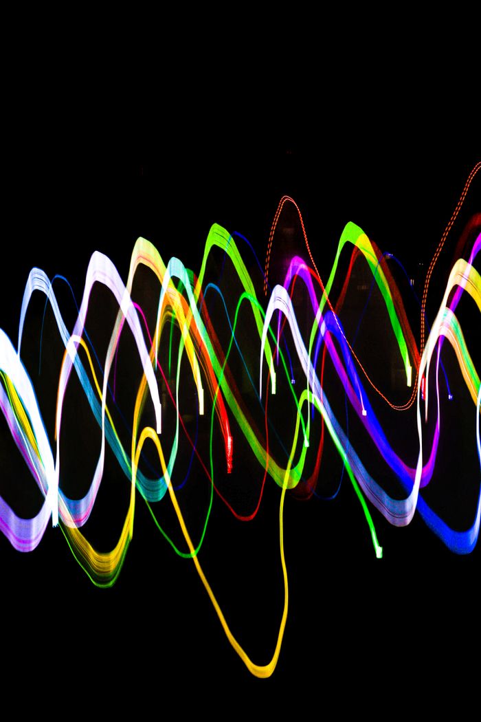 Colorful abstract light trails creating a vivid pattern against a dark backdrop.